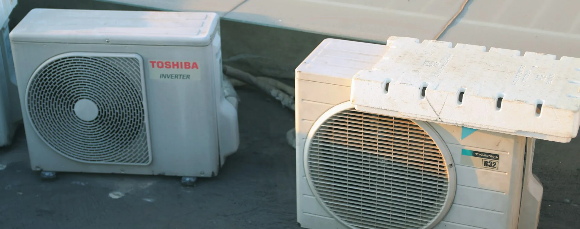Two outdoor AC condenser units on a rooftop