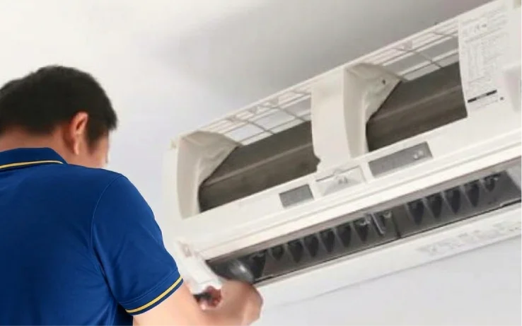 Technician cleaning the filters of a wall-mounted split AC